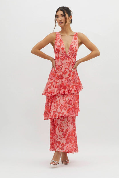 Front view of coral floral ruffle midi dress with layered skirt detail