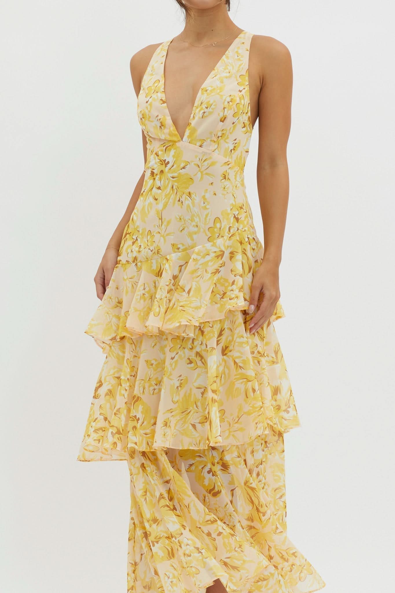 Side detail of yellow print midi dress showing layered ruffle construction