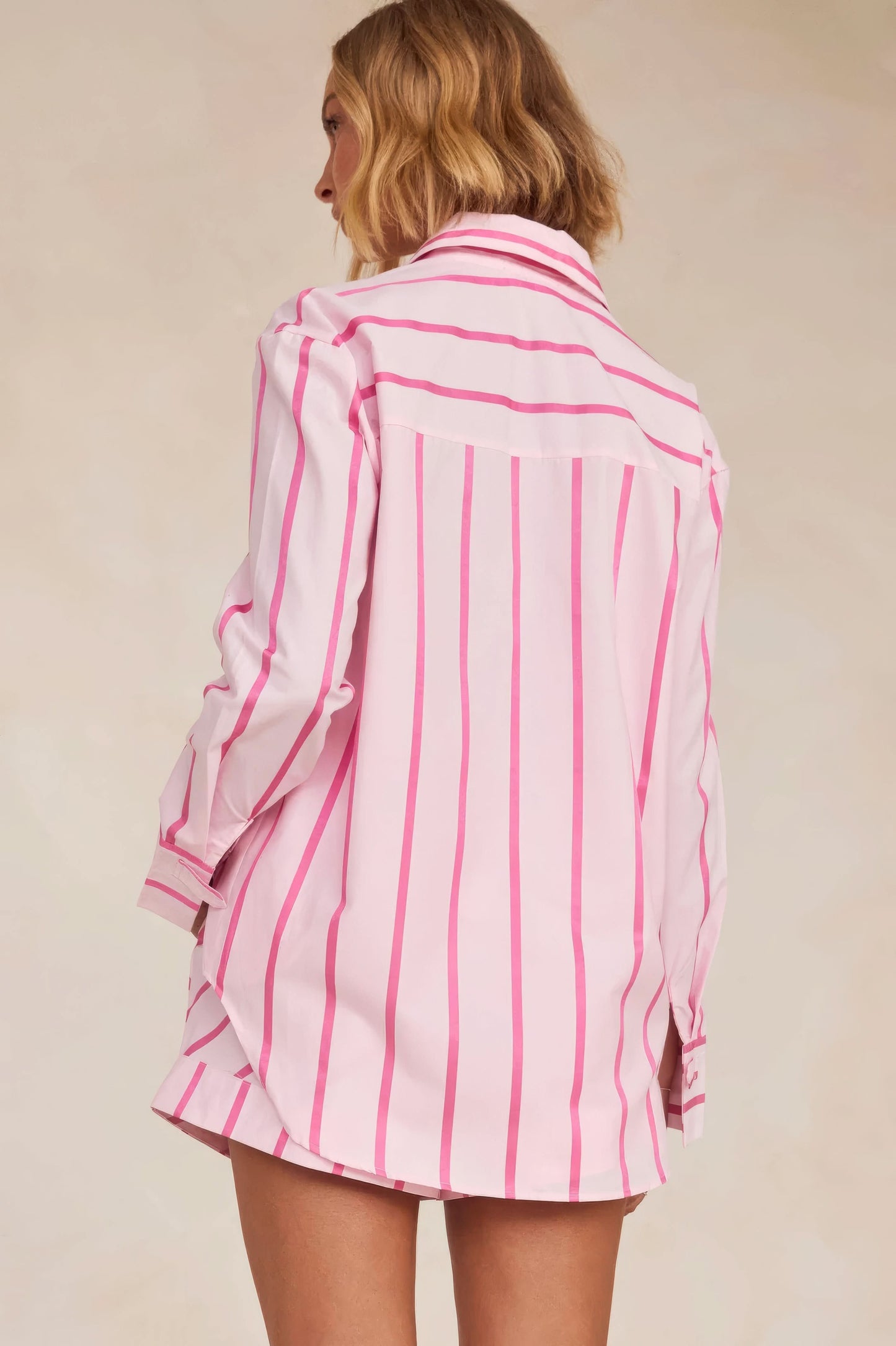 Back view of pink striped knit shirt with matching pleated skirt