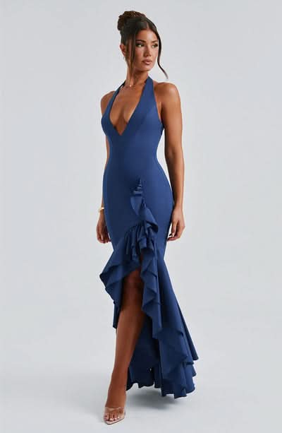Navy halter formal dress with cascading ruffled asymmetrical skirt and open back
