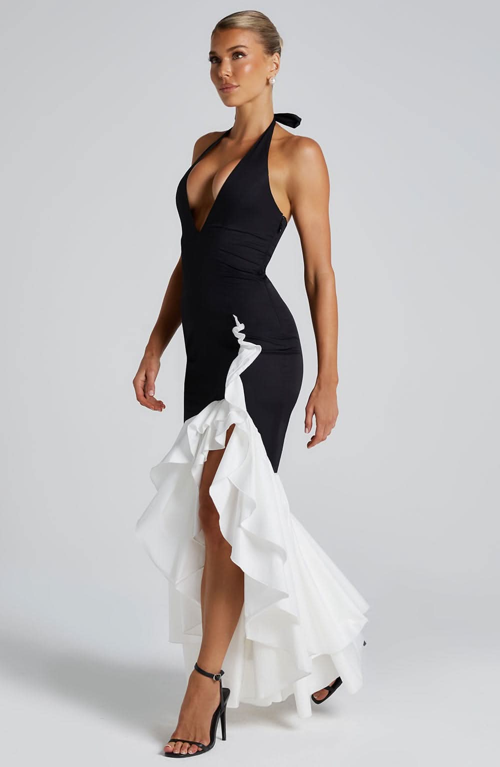 Black halter formal dress with asymmetrical white ruffled train and deep v-neckline