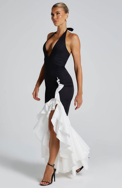 Black halter formal dress with asymmetrical white ruffled train and deep v-neckline