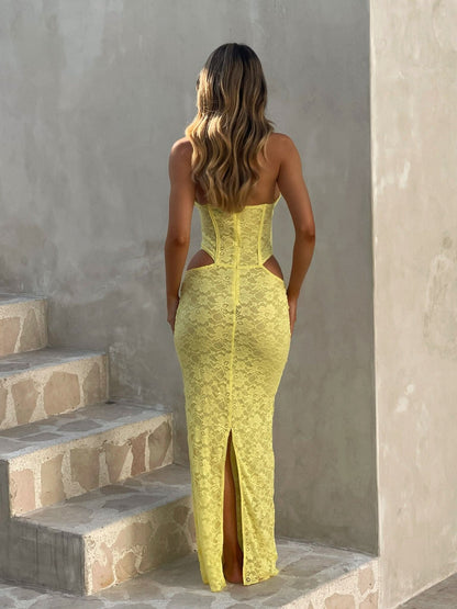 Back view of yellow lace maxi dress showing corset back and slit hem detail