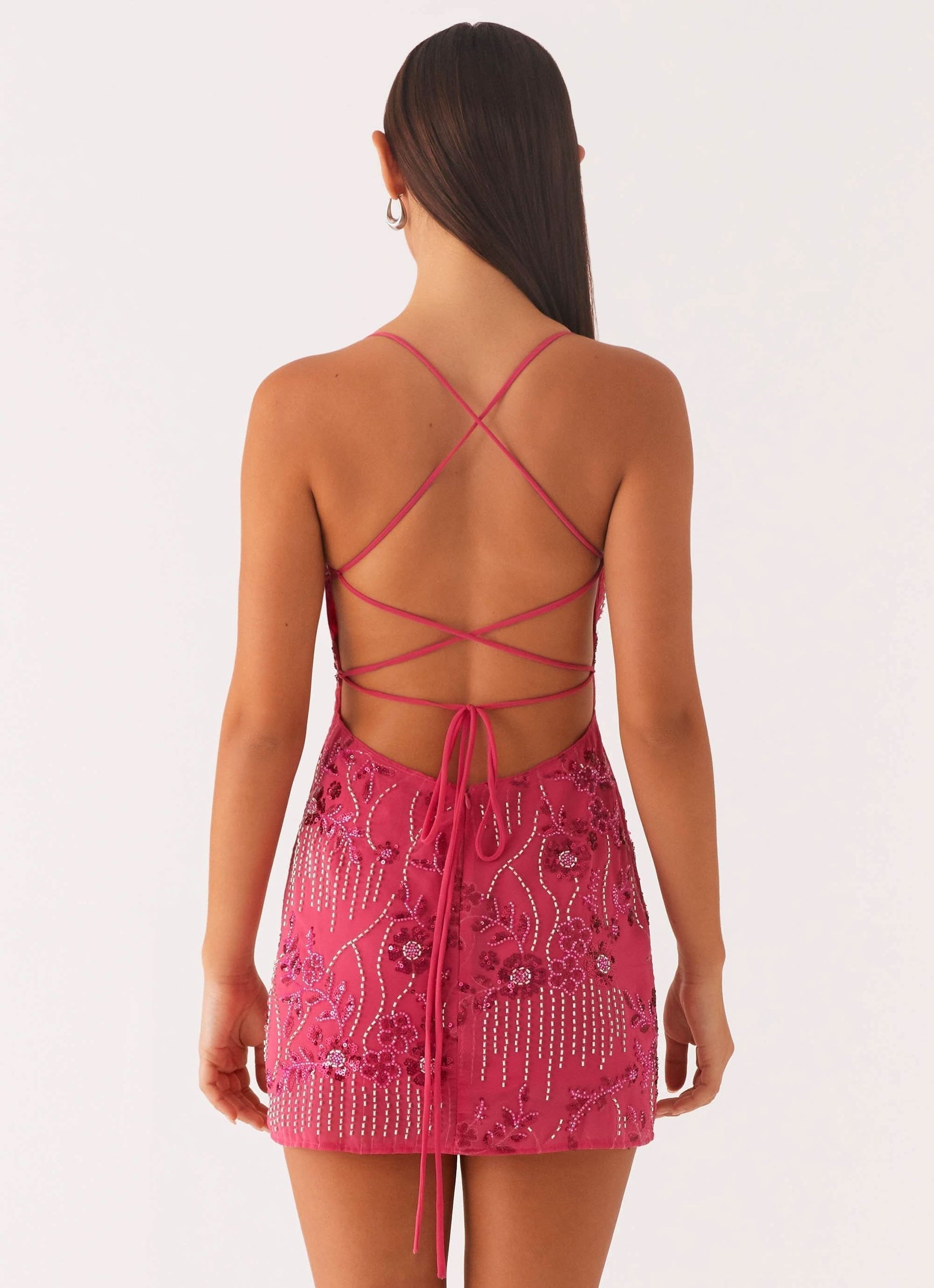 Back view of pink sequin dress with lace-up strappy design