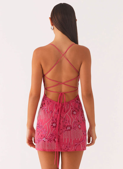 Back view of pink sequin dress with lace-up strappy design