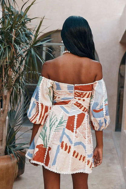 Back view of mini dress showing corset-style lacing and abstract print details