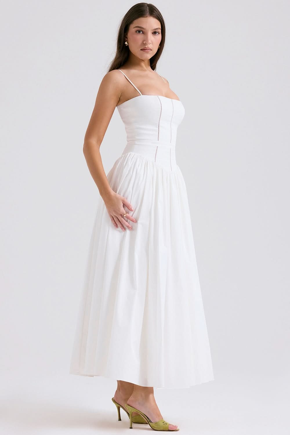 White midi dress with spaghetti straps and flowing pleated skirt side view
