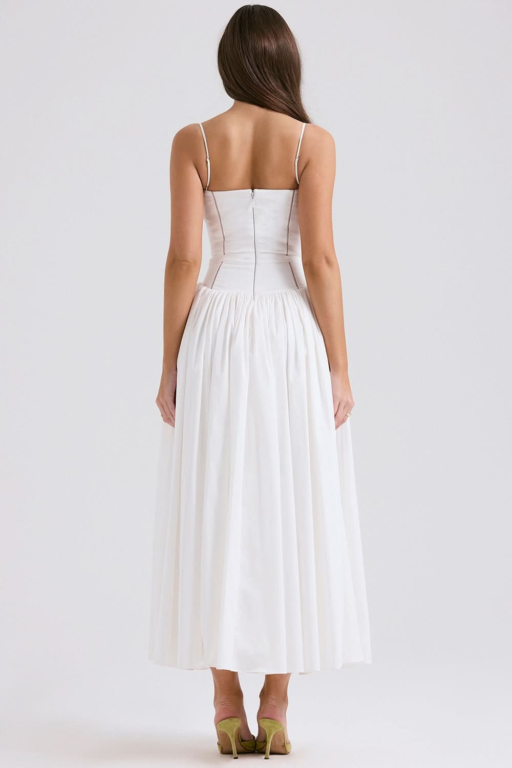 Back view of white midi dress showing structured bodice and pleated skirt