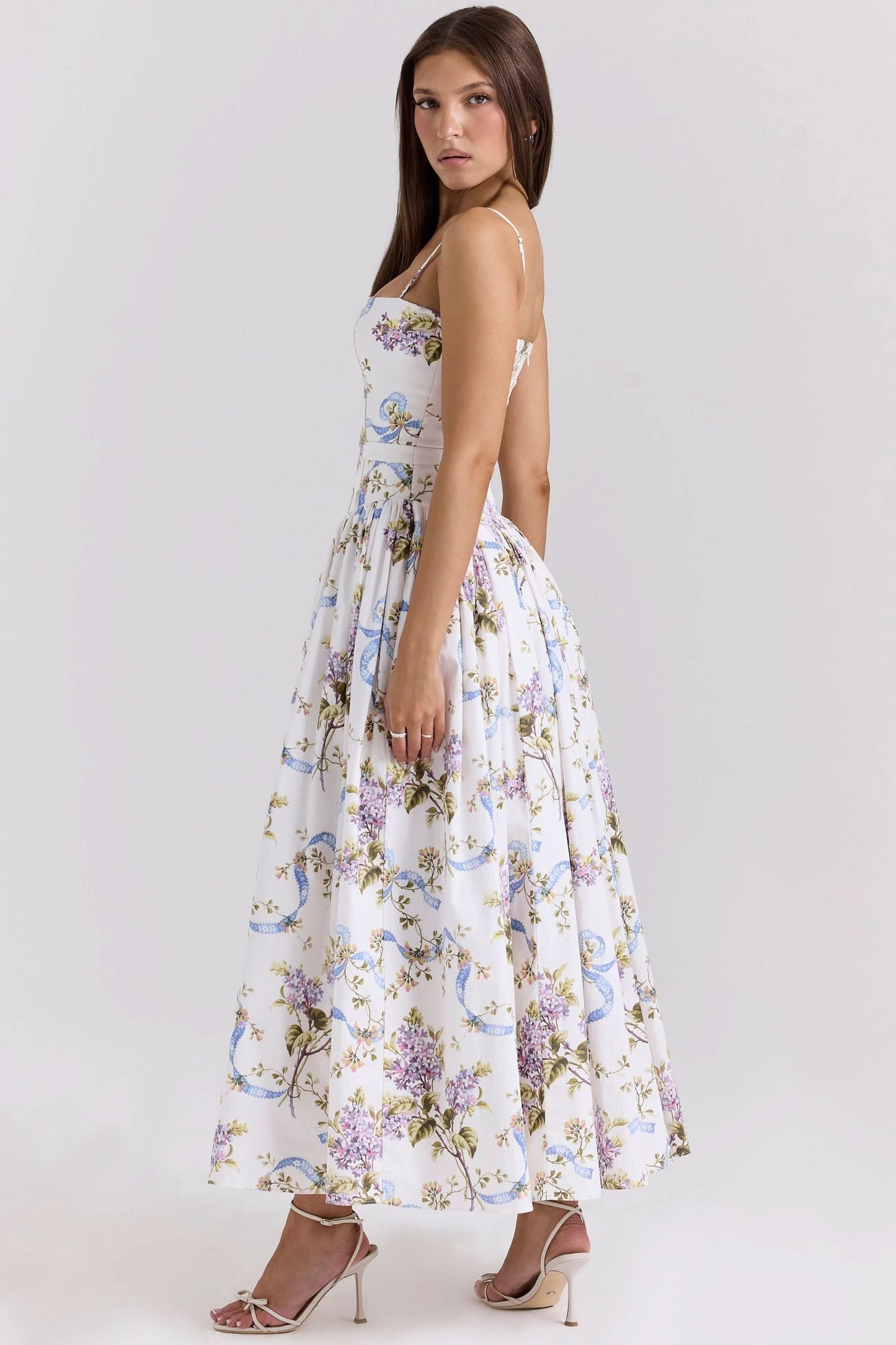 Back view of white floral midi dress with spaghetti straps and gathered skirt