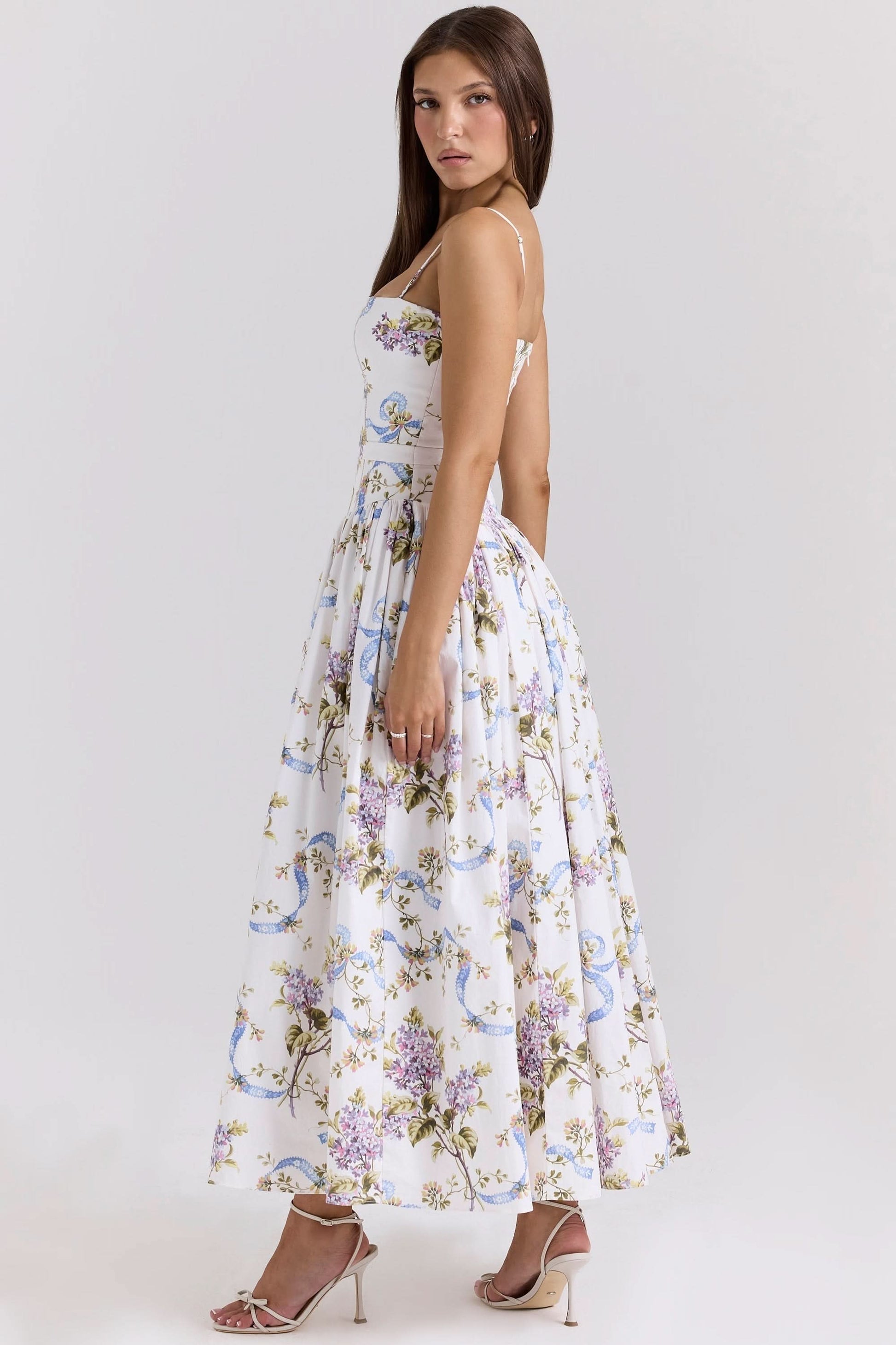 Back view of white floral midi dress with spaghetti straps and gathered skirt