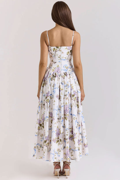Back view showing fitted waist and full pleated skirt of floral midi dress