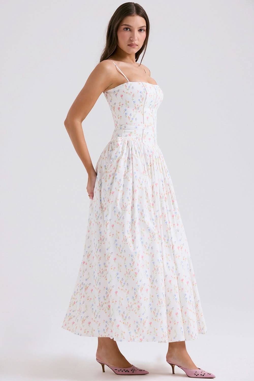 Side view of cream floral midi dress with spaghetti straps and gathered skirt