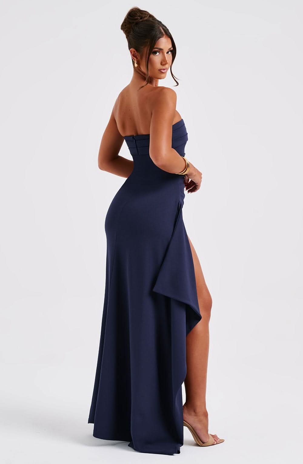 Back view of navy strapless maxi dress with asymmetrical hem