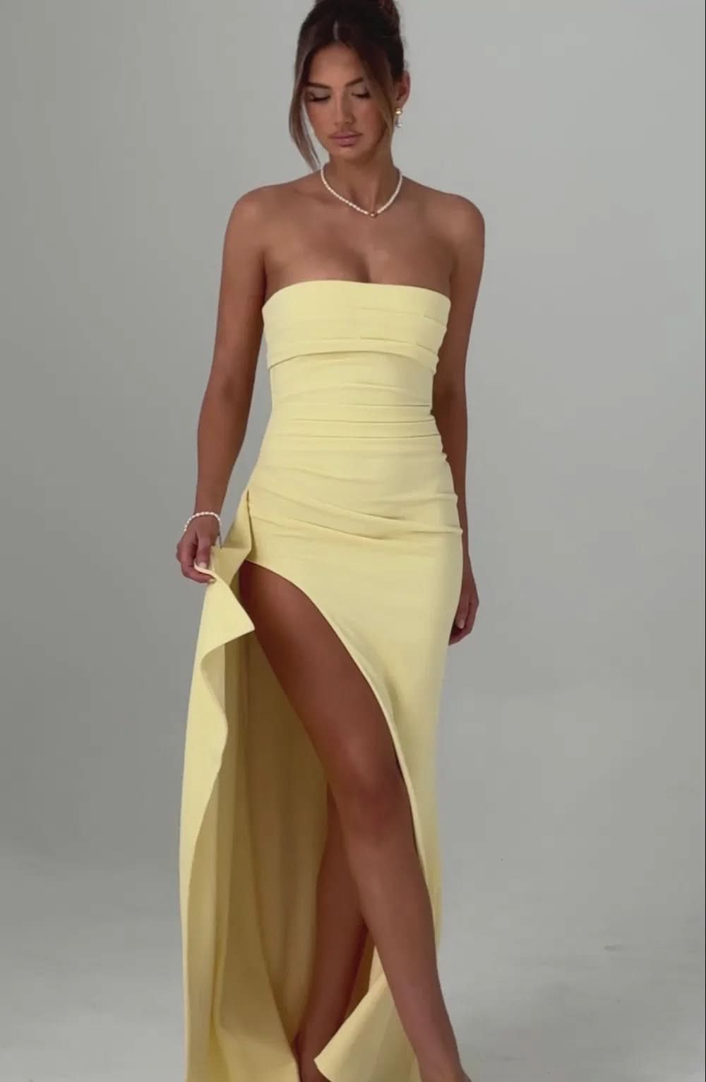 Pale yellow strapless maxi dress with ruching and side slit