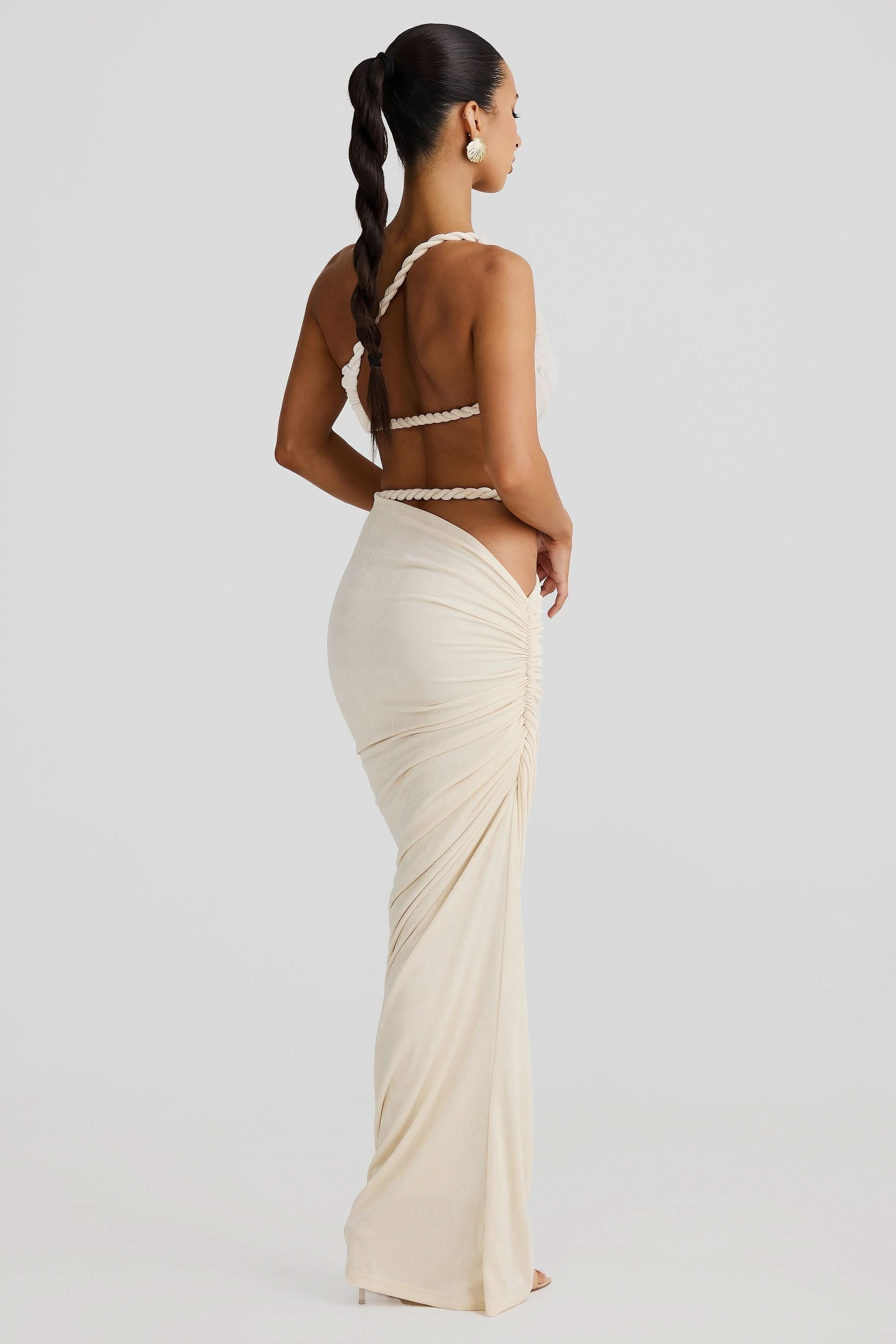 Back view of cream maxi set with rope-trimmed bandeau and draped skirt