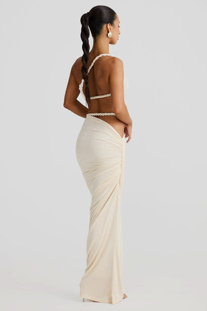 Back view of cream maxi set with rope-trimmed bandeau and draped skirt